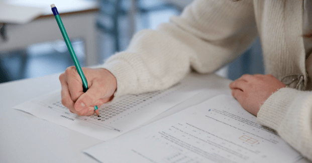A student writing answers in an exam